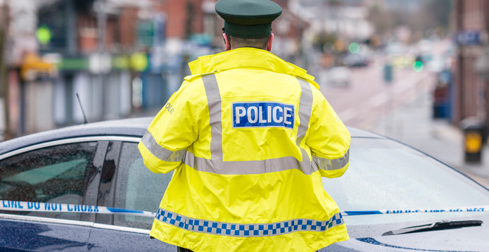 PSNI A police officer stands guard following a bomb attack stock photo card