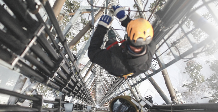 Telecommunication worker repairing antenna