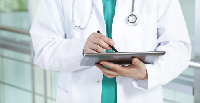 Doctor writing on pad