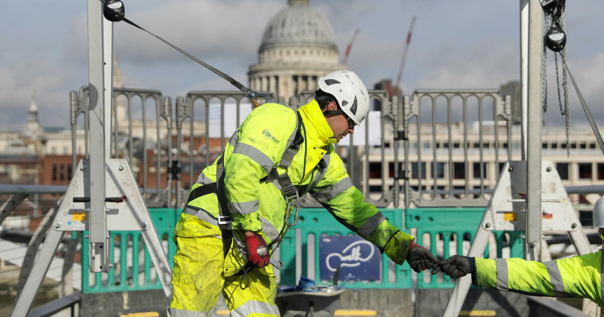 Construction worker on Londons Millennium BridgeDigital  SEOSocialEditorial image