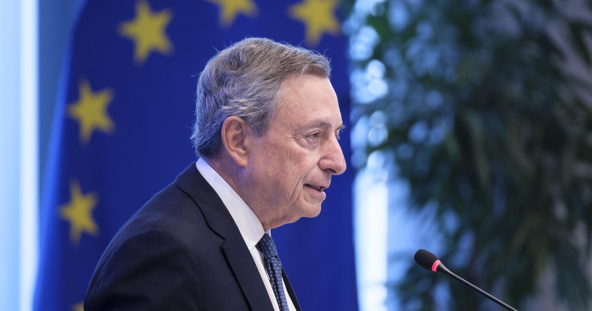 Mario Draghi with EU flag behind_Digital - SEOSocialEditorial image