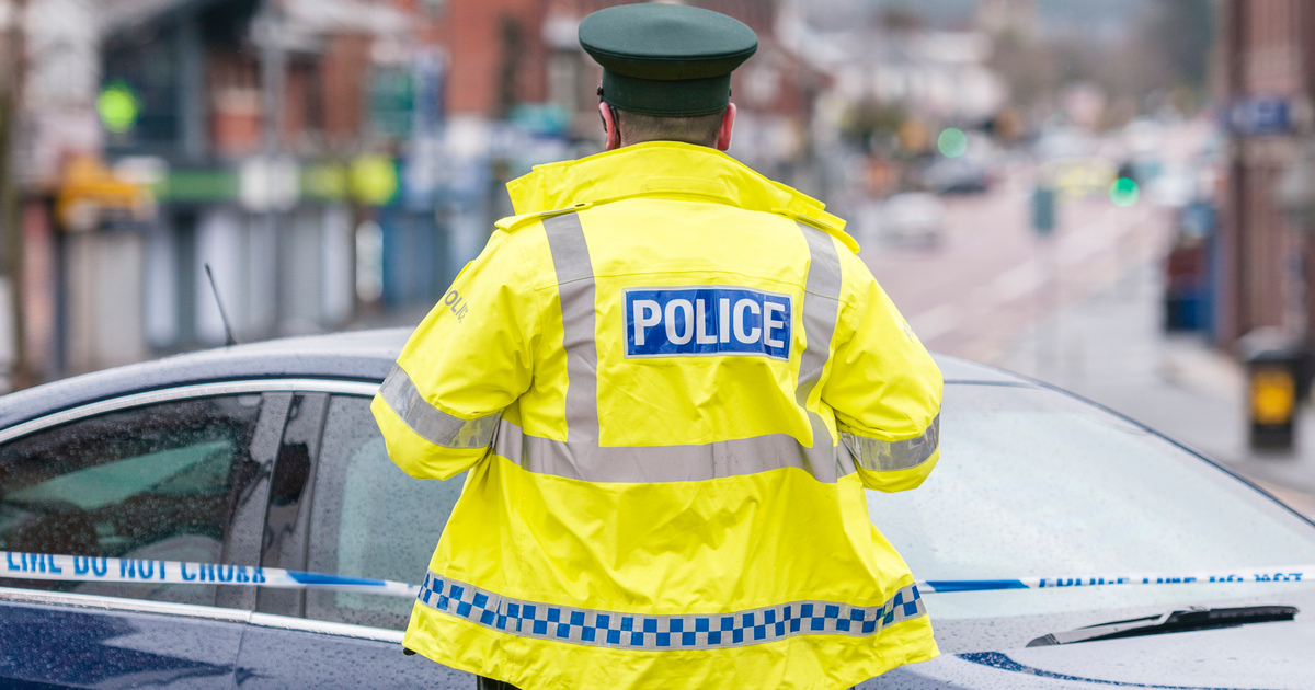PSNI A police officer stands guard following a bomb attack stock photo seo