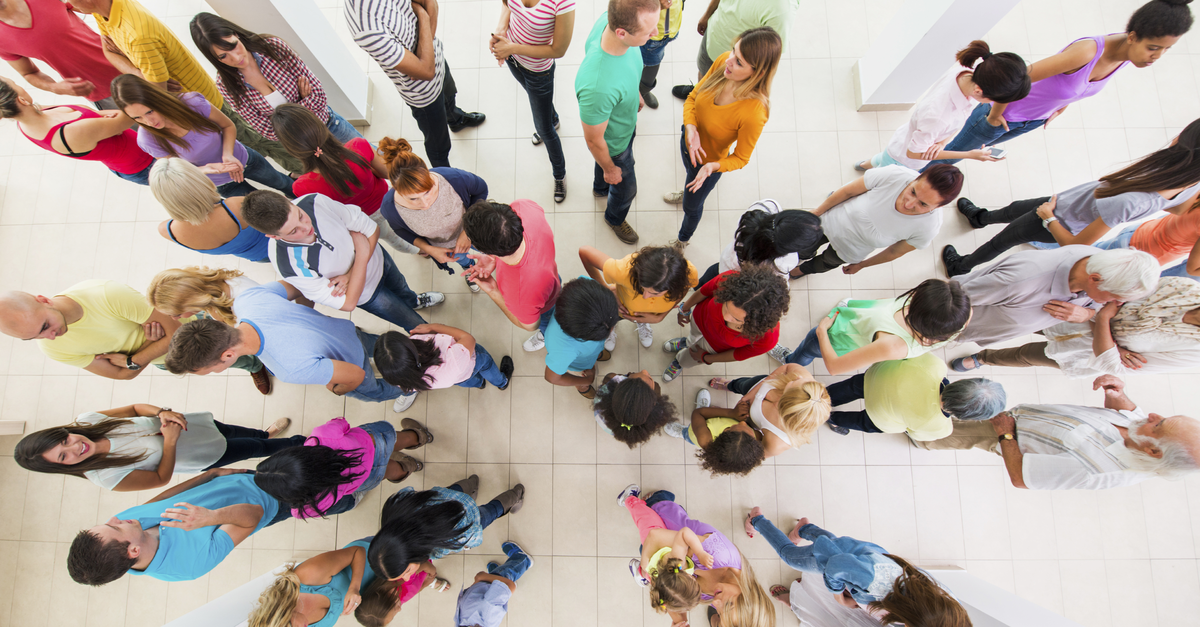 Above view of large group of people communicating - diversity